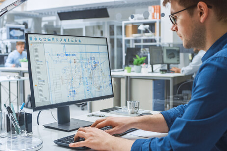 Un uomo lavora ad uno studio di ingegneria al computer foto iStock.