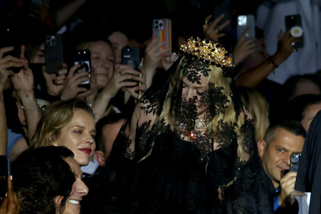 Coberta com um longo véu negro, Madonna acompanhou o desfile da Dolce &amp; Gabbana em Milão